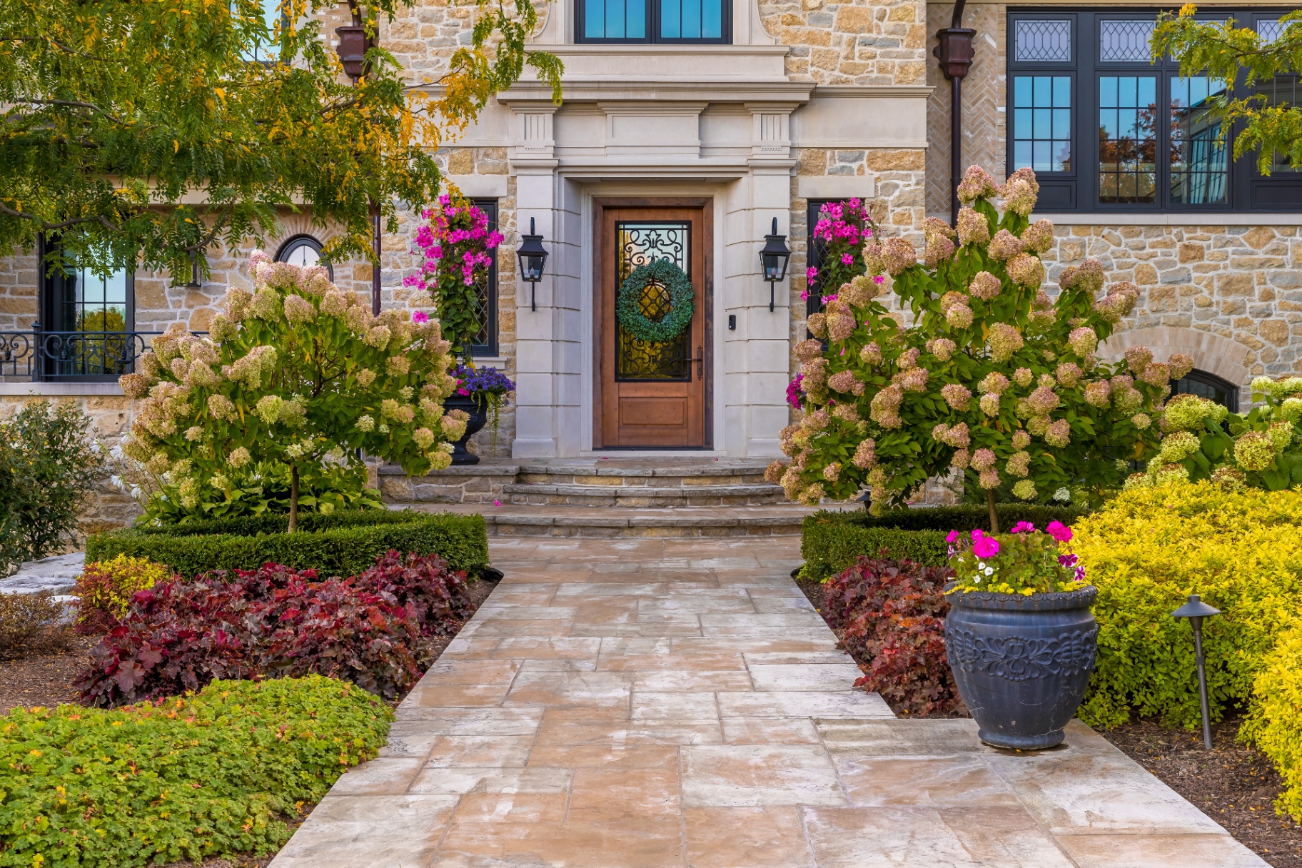 Modern Chateau — Stone-paved entrance walkway in bloom