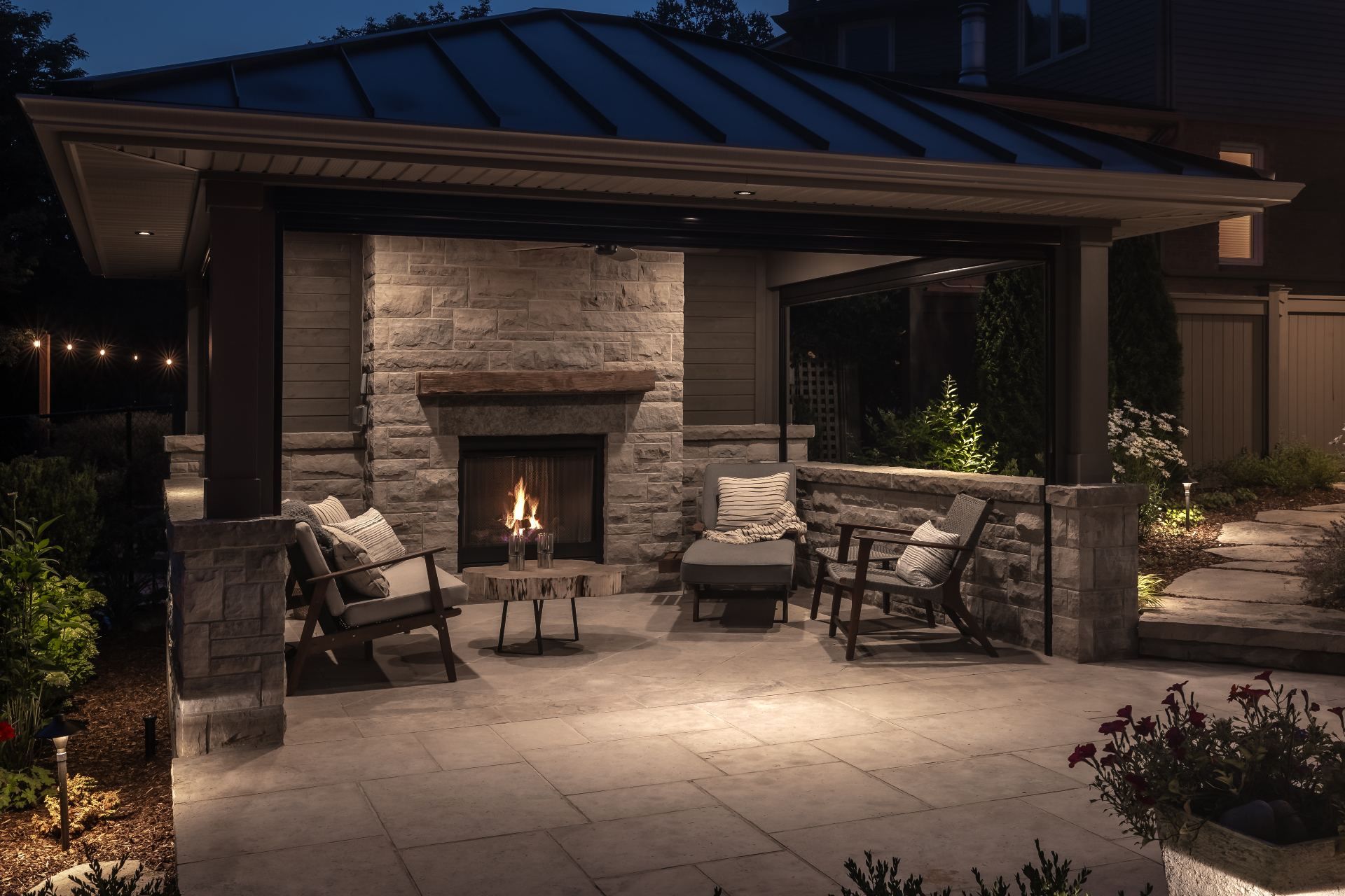 Covered stone fireplace pavilion at dusk