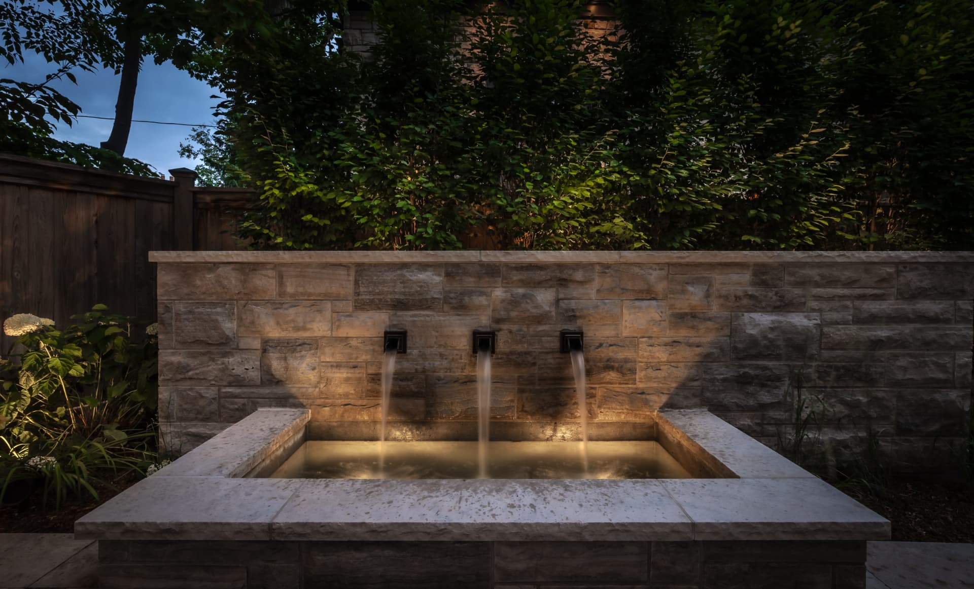 The Renaissance Retreat — Illuminated stone water wall