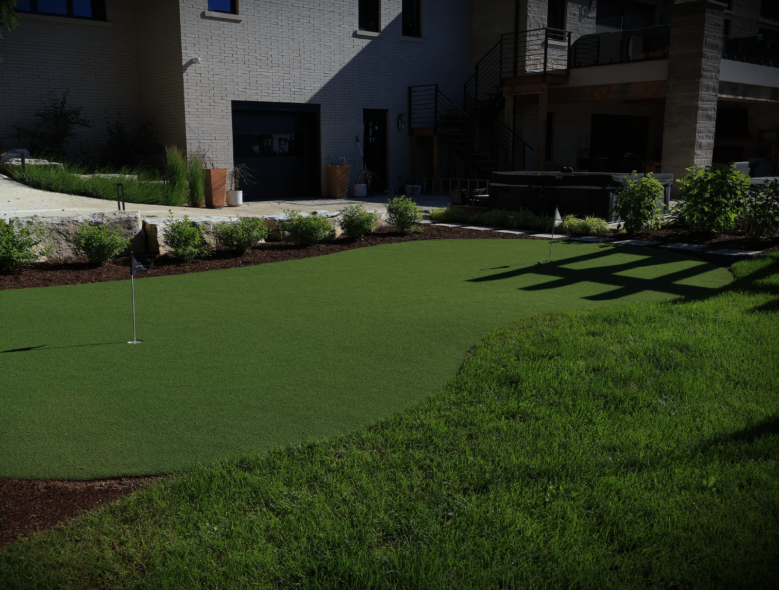 Private putting green beside a contemporary estate
