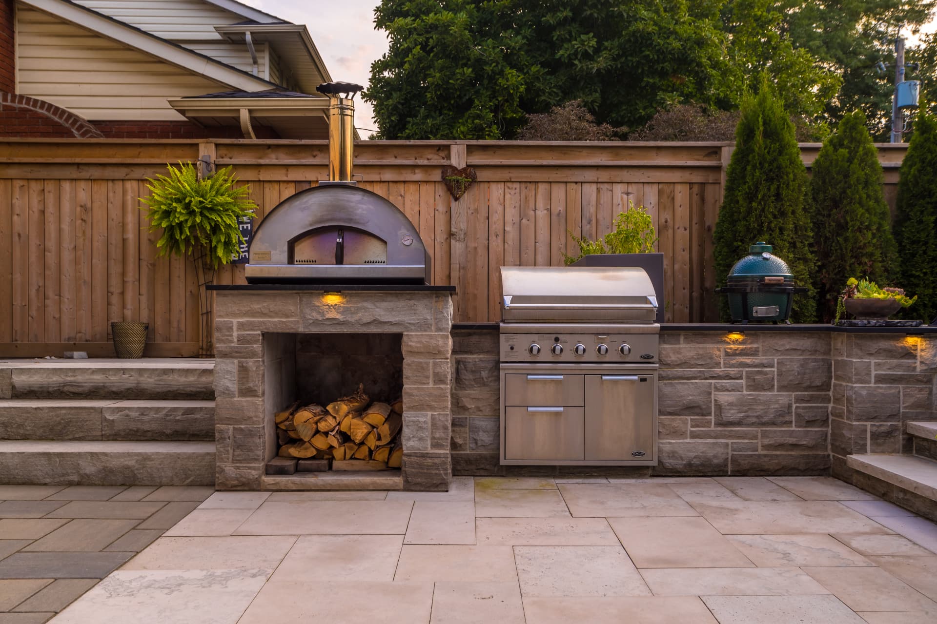 Outdoor kitchen with pizza oven, gas grill and Big Green Egg