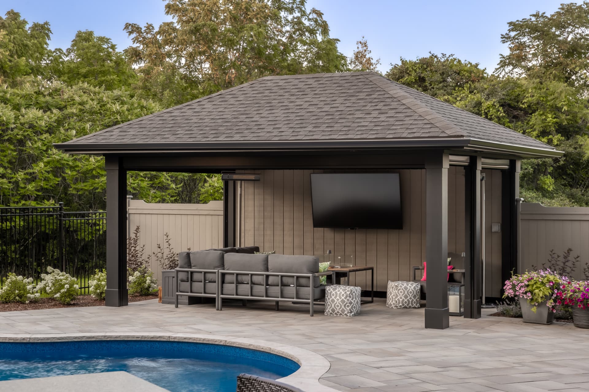Pool pavilion with lounge seating and privacy screens